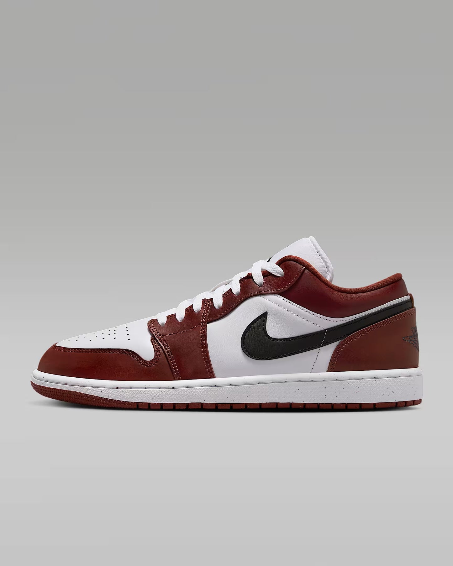 A pair of Nike Air Jordan 1 Low SE sneakers with a red and white color scheme.