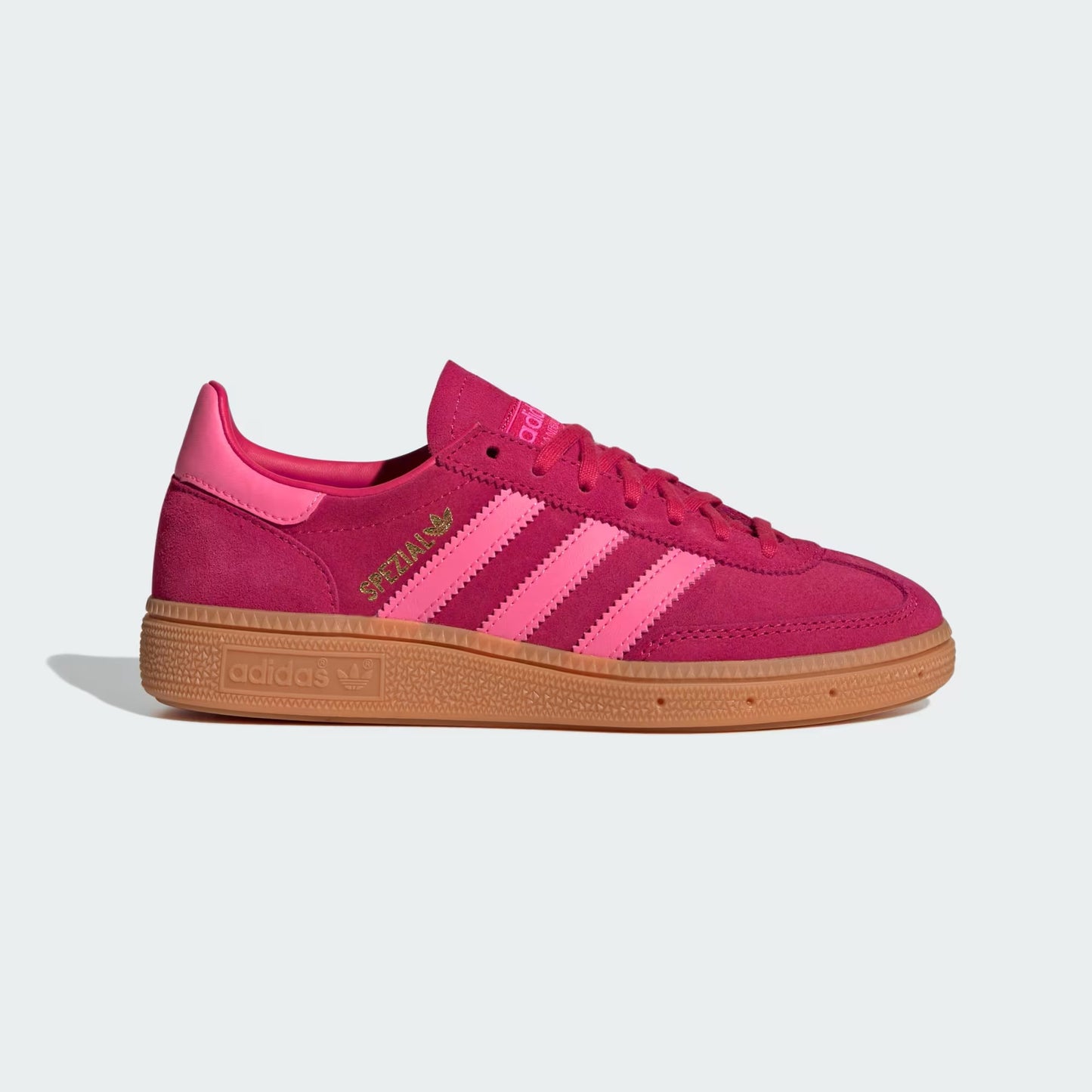 Pink Adidas sneaker with gold accents on a light gray background