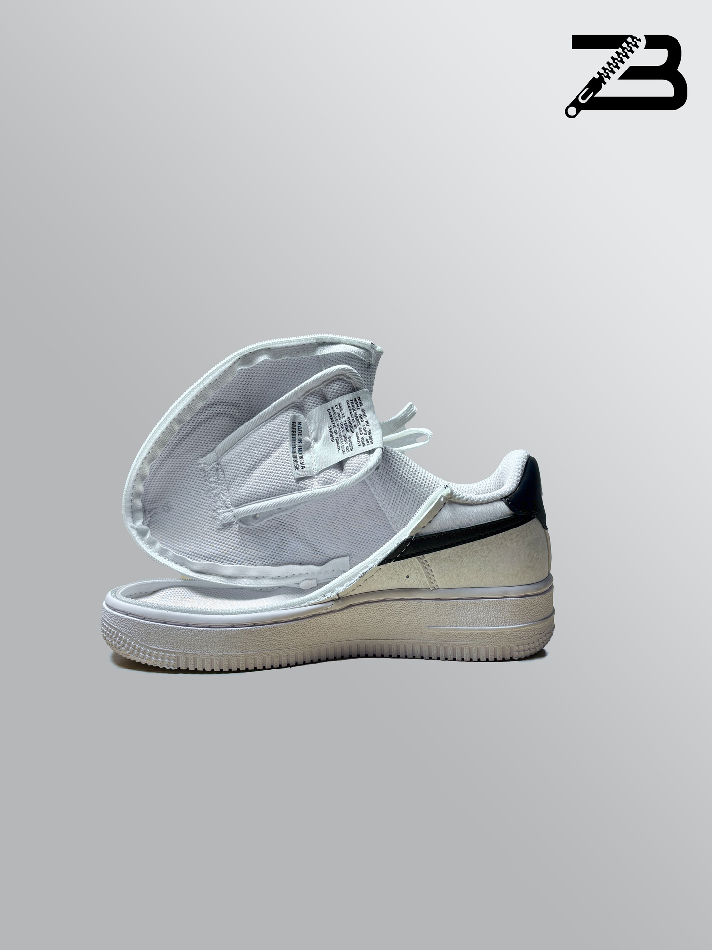 White nike shoe with a zipper on a gray background