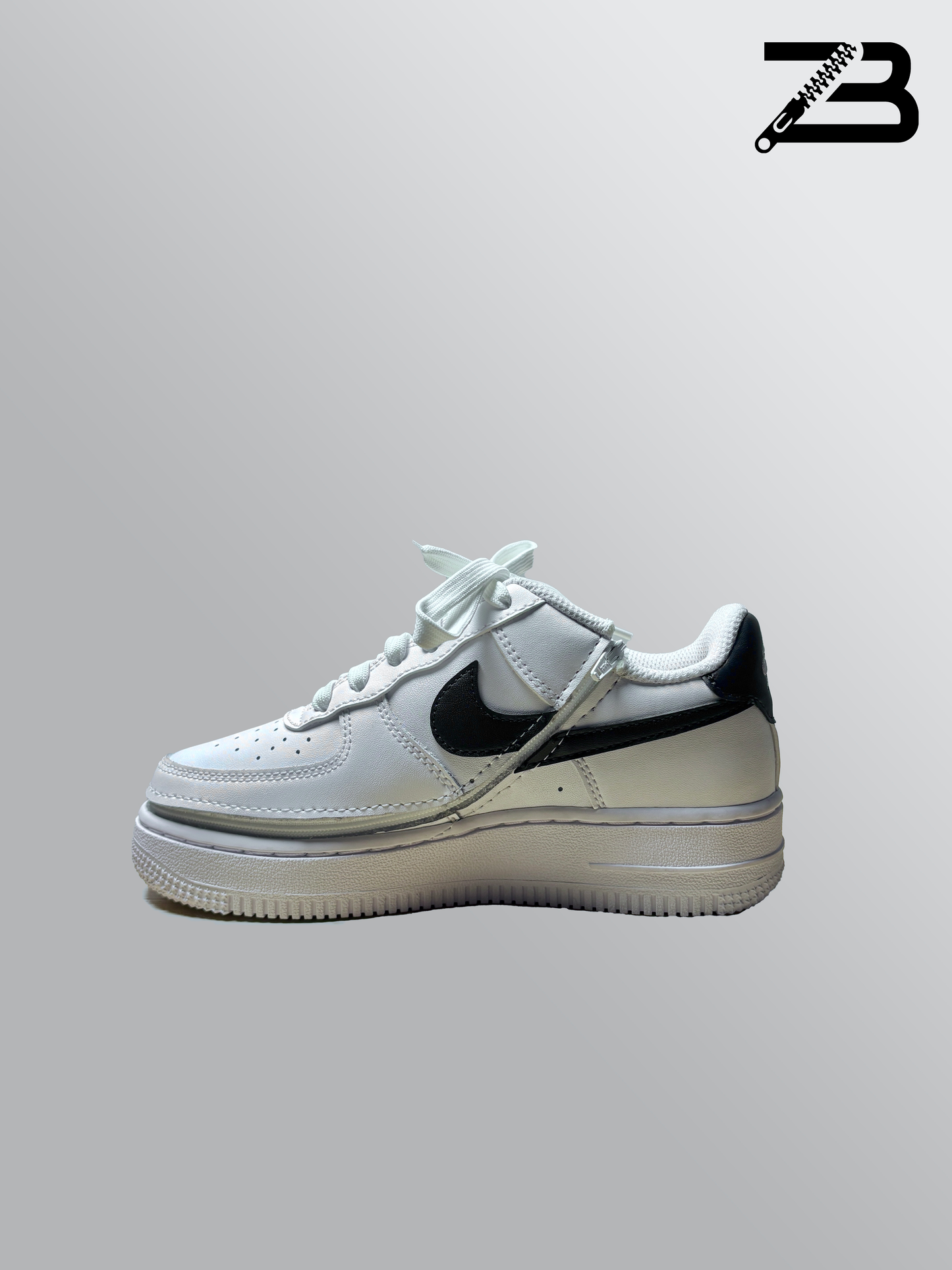 White nike shoe with a zipper on a gray background