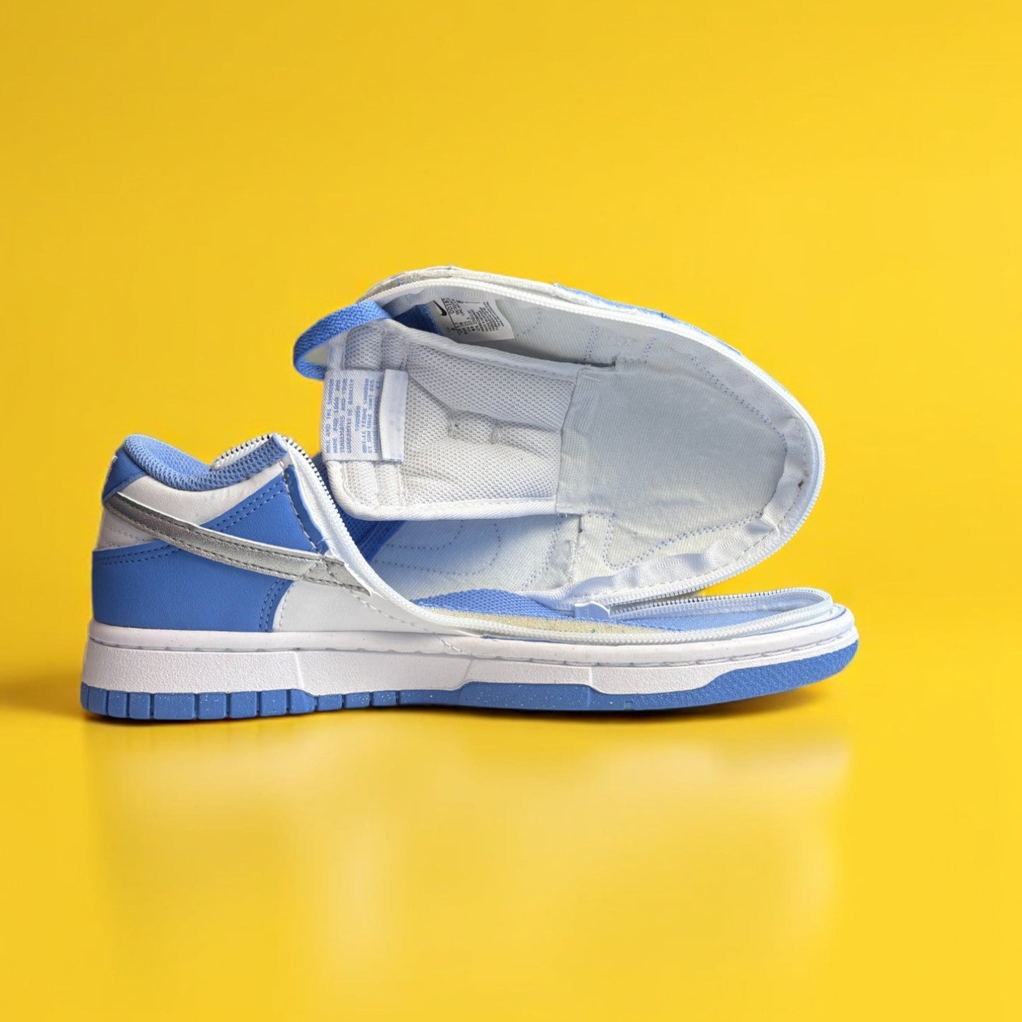 Blue and white Nike dunk next nature with a zipper on yellow background