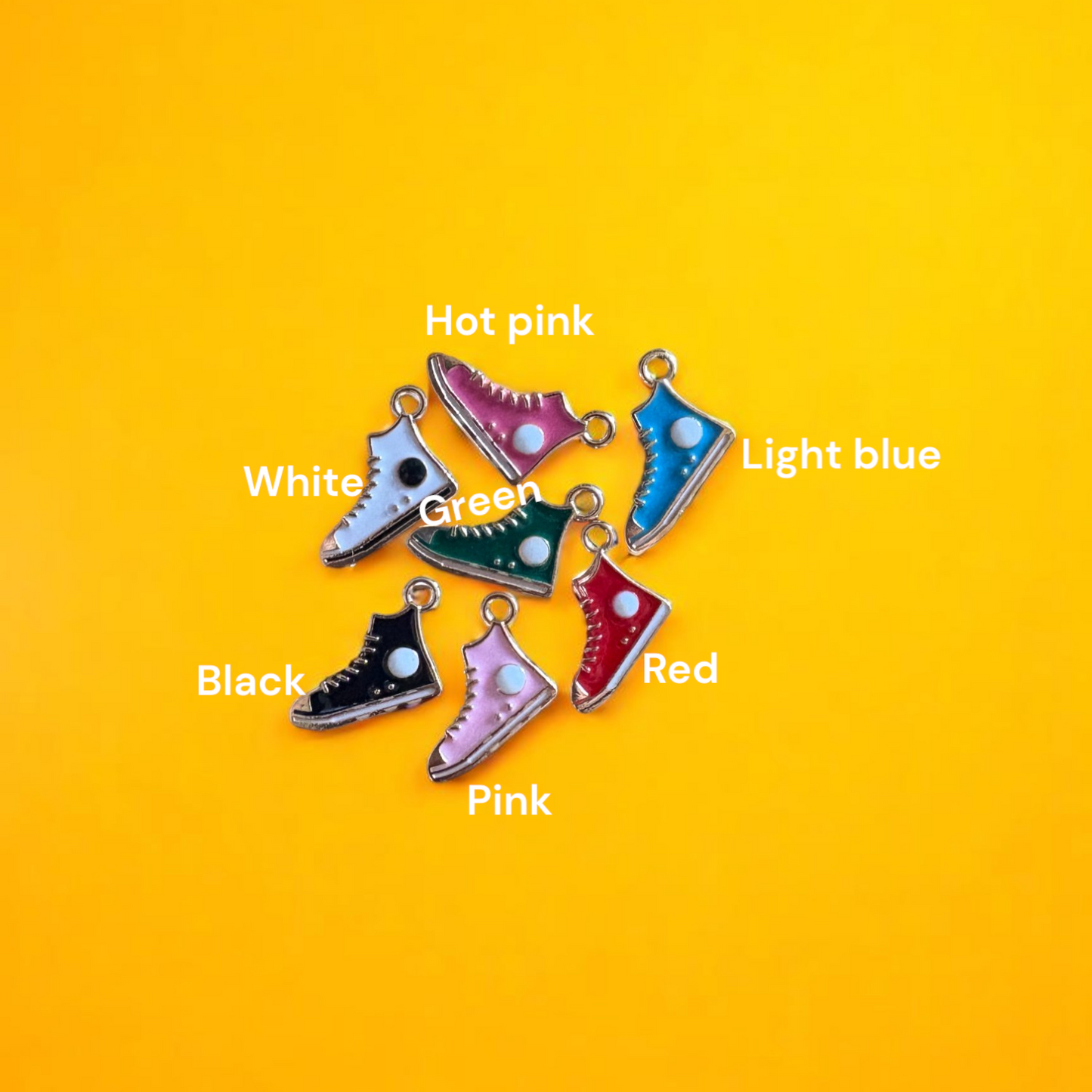 A collection of colorful shoe-shaped charms displayed on a yellow background.