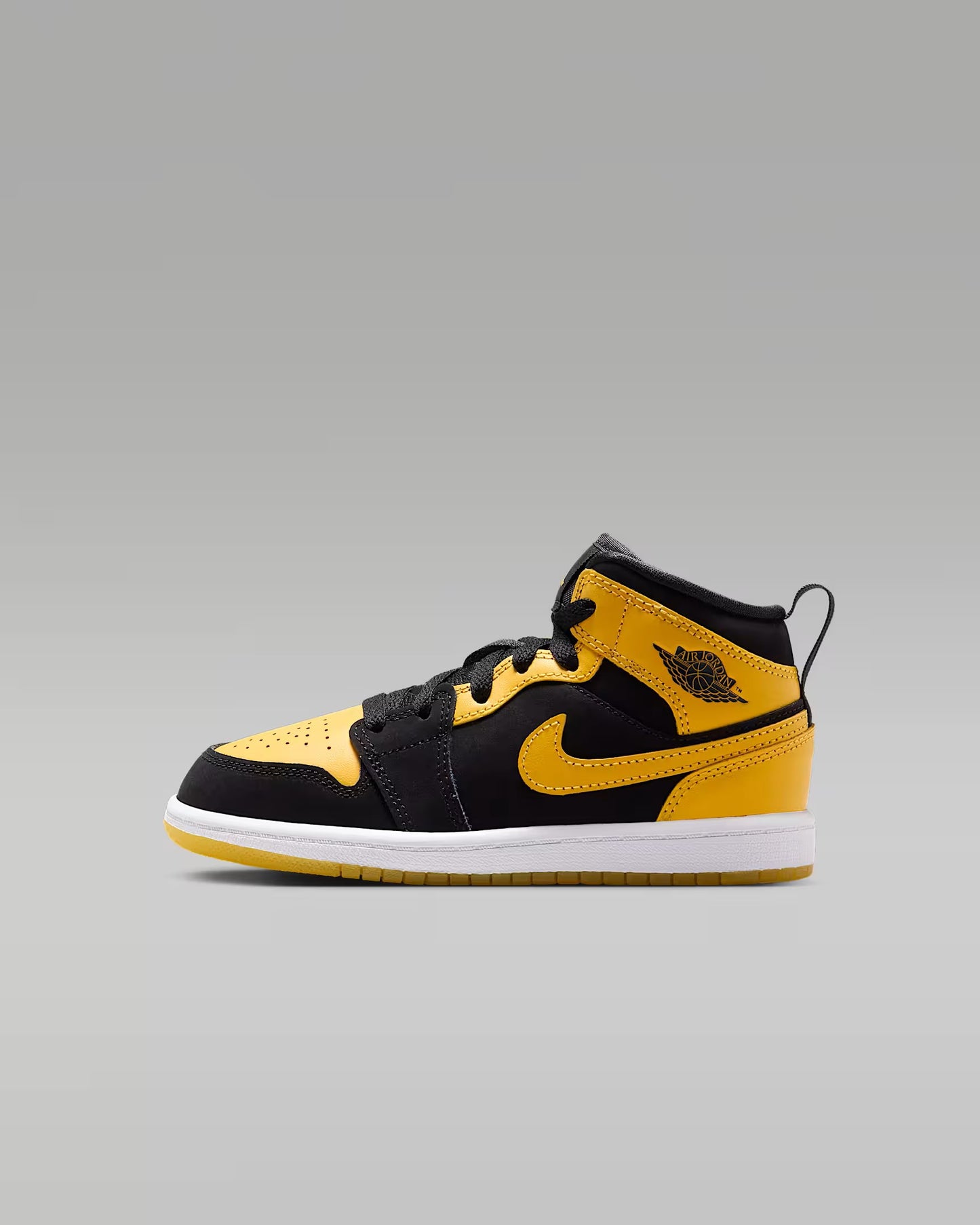 Black and yellow sneaker with a prominent brand logo on a gray background