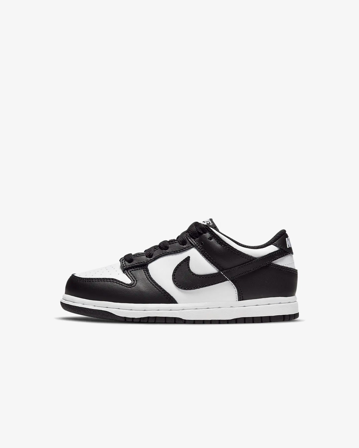 A pair of kids' Nike Dunk Low sneakers in white and black