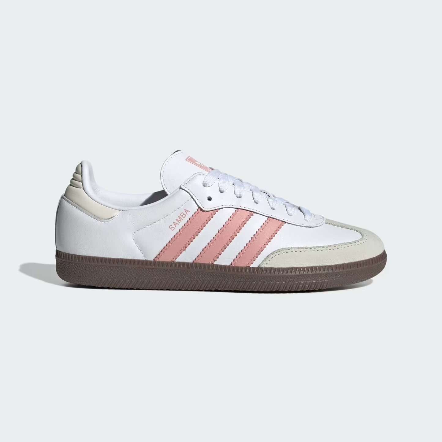 White Adidas sneaker with pink stripes on a light gray background