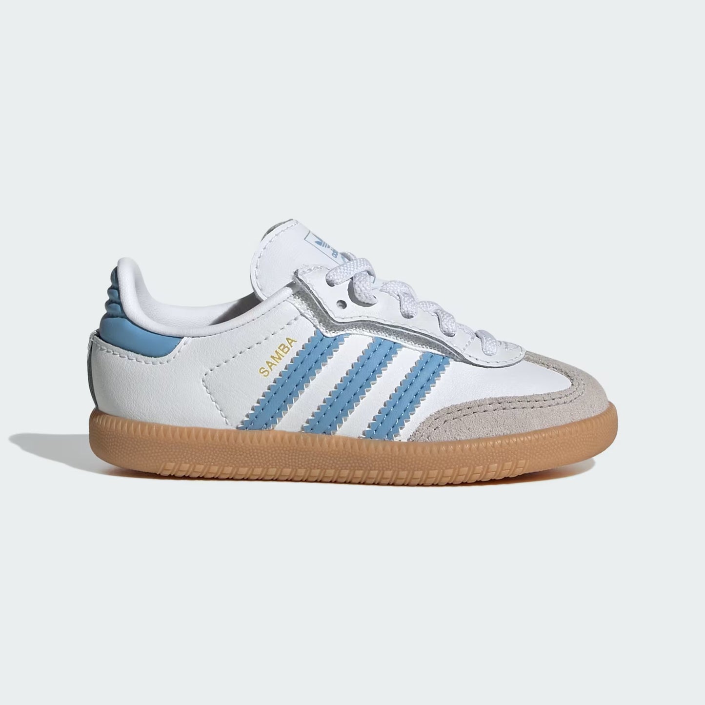 White and blue Adidas sneaker with brown sole on a light gray background
