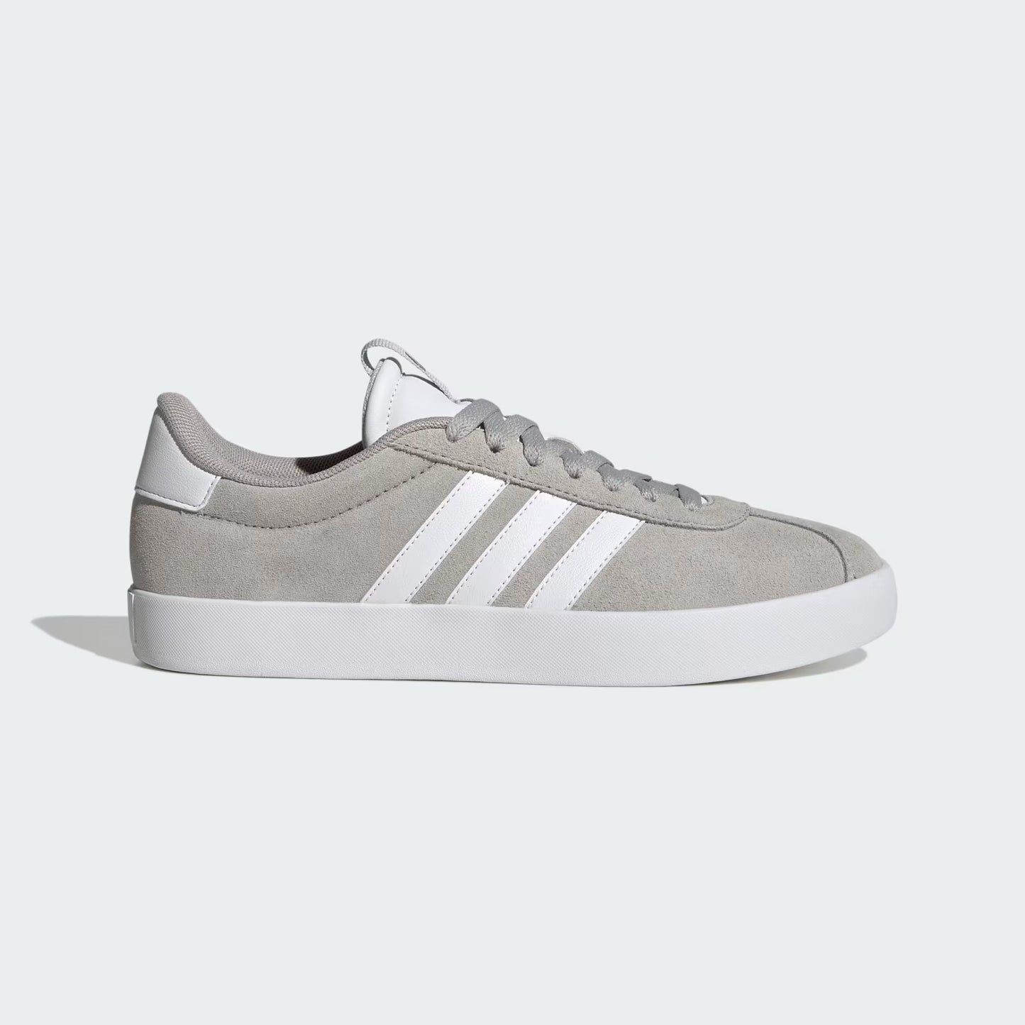 Gray Adidas sneaker with white stripes on a light gray background