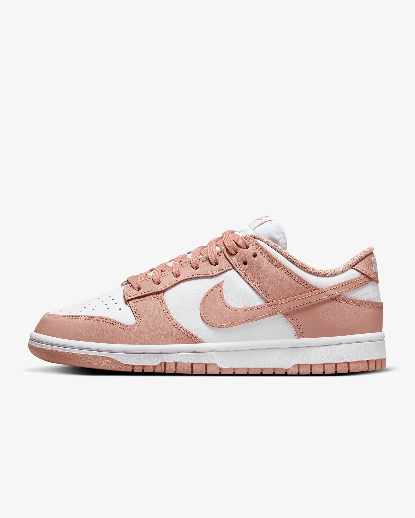 A pair of beige and white Nike Dunk Low sneakers