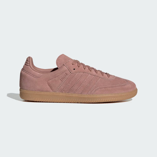 Pink Adidas sneaker with brown sole on a light gray background