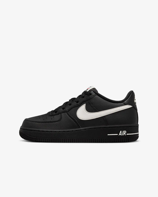 A kids black and white Nike Air Force 1 shoe 