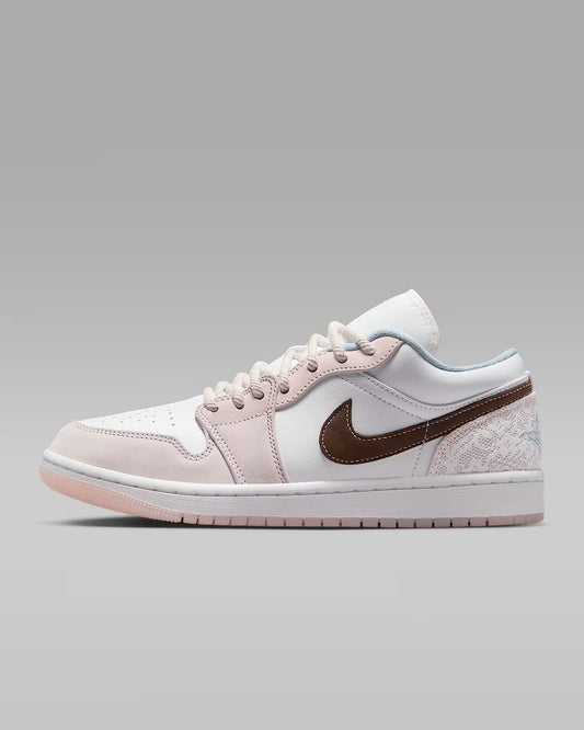 A pair of Women's Nike Air Jordan 1 Low sneakers in white and brown colors
